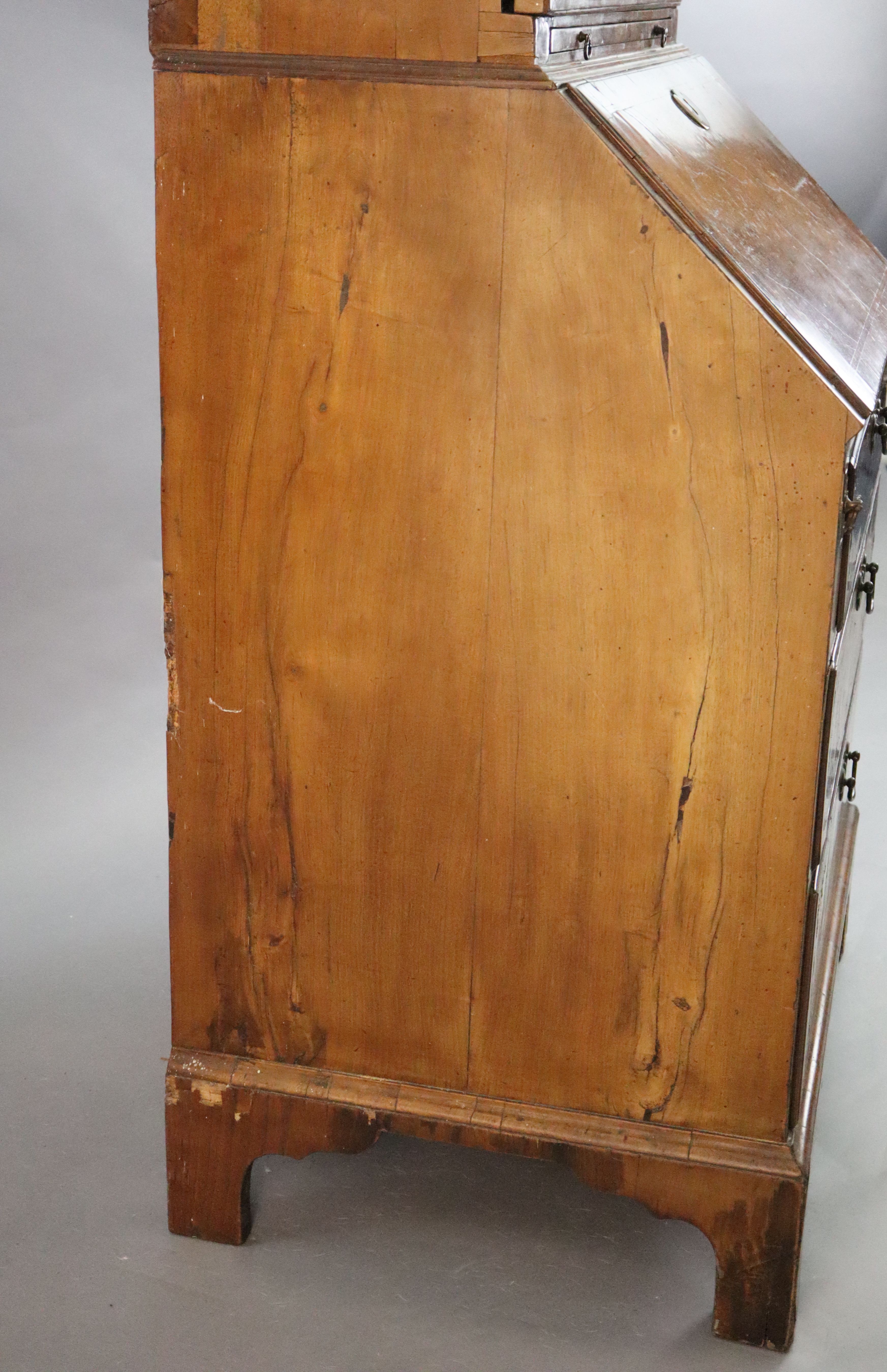 An early 18th century banded walnut bureau bookcase W. 2ft 4in. H. 6ft 6in. D. 1ft 8in.